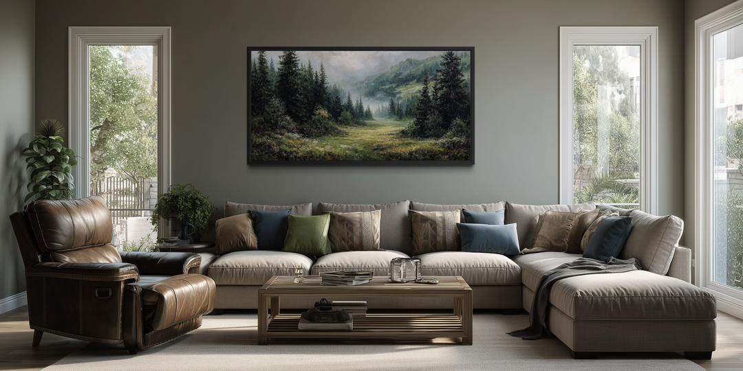 Misty mountain meadow and pine forest canvas wall art displayed above a large sectional sofa.