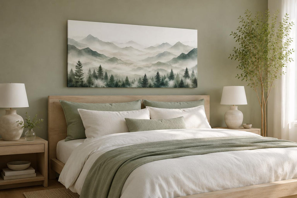 Misty mountain and pine tree canvas painting in sage green above a bed in a minimalist bedroom.