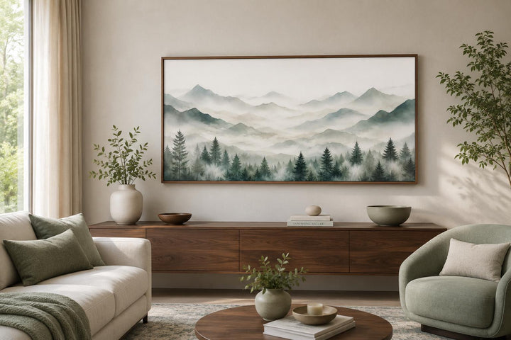 Misty mountain and sage green pine tree canvas wall art displayed above a wooden console table.