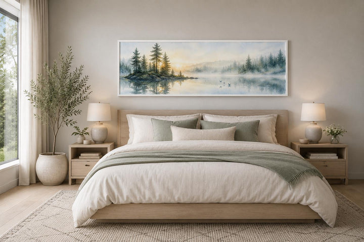 Panoramic misty pine forest wall art above a bed in a neutral, nature-inspired bedroom.