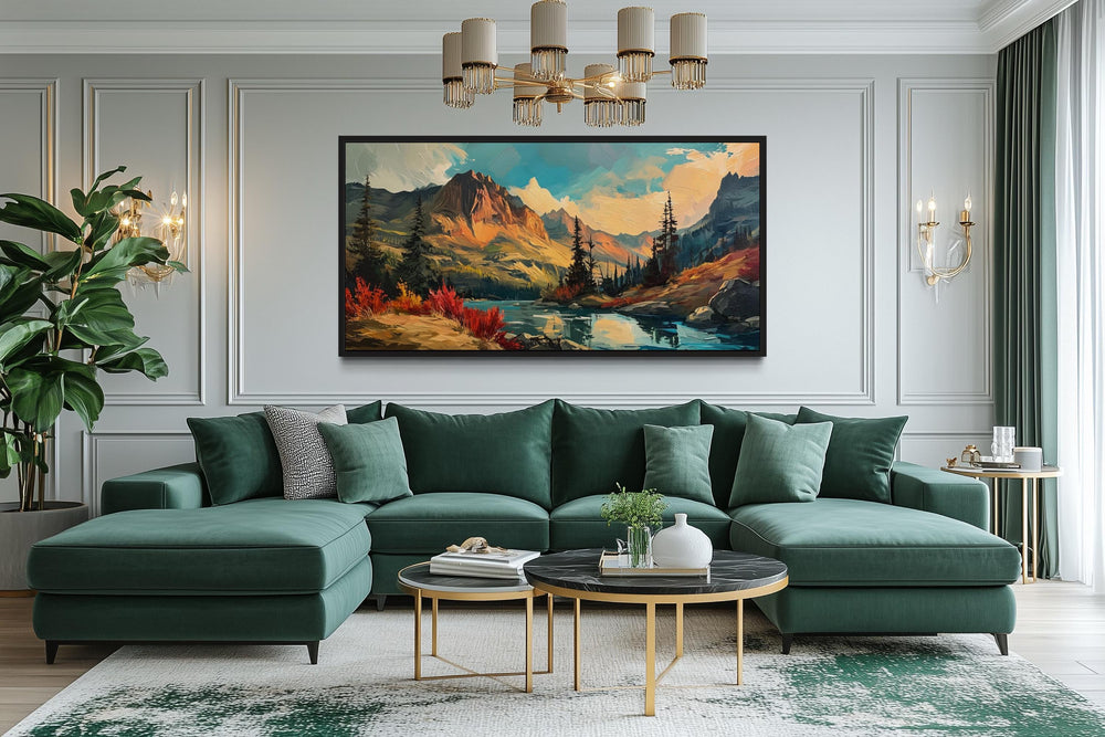 Modern abstract framed canvas wall art of a mountain lake sunset in autumn above a green sofa.