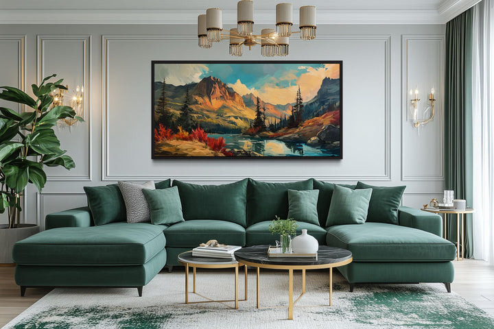 Modern abstract framed canvas wall art of a mountain lake sunset in autumn above a green sofa.