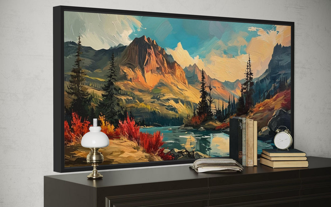 Modern abstract framed canvas art of a mountain lake sunset in autumn above a dark wood dresser.