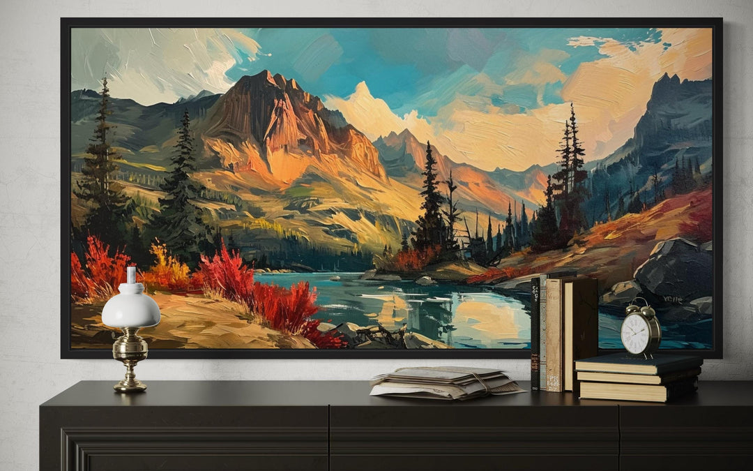 Modern abstract framed canvas wall art of a mountain lake sunset in autumn above a dark sideboard.