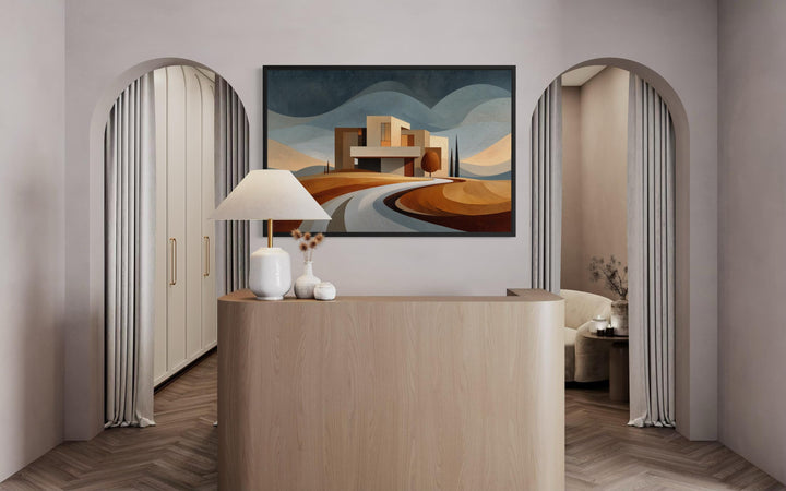 Modern architecture canvas print featuring a desert-style home above a curved road in an office.