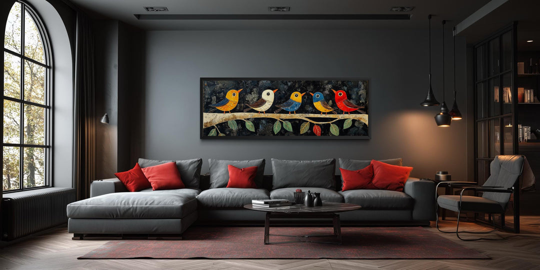 Modern folk style birds on a branch long narrow canvas wall art above a grey sofa in a dark room.