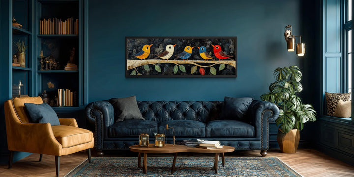Modern folk style canvas wall art featuring colorful birds on a branch above a blue sofa.