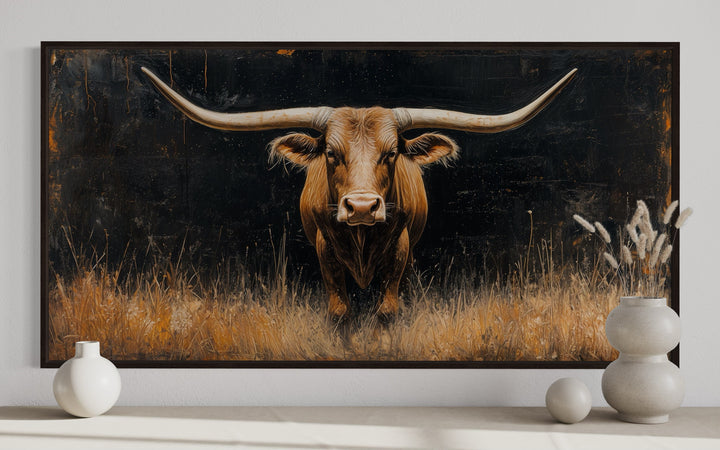 Framed canvas wall art of a Texas longhorn steer in golden grass with a dark, textured background.