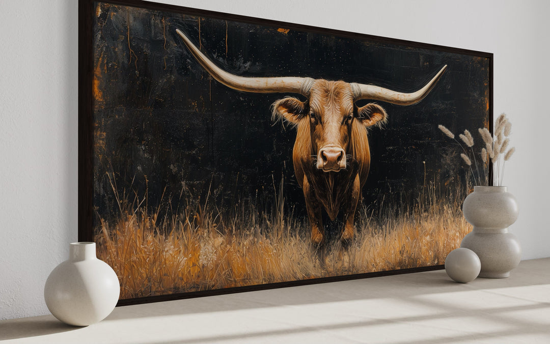 Modern Texas longhorn steer in golden grass framed farmhouse canvas wall art on a neutral wall.