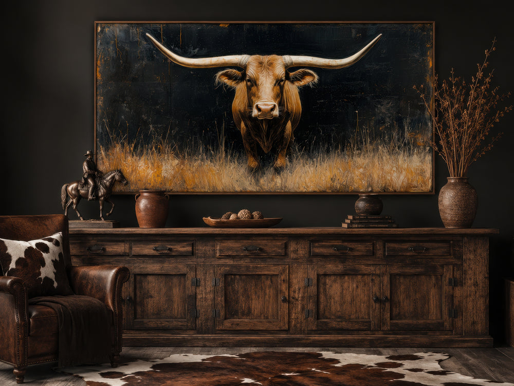 Modern Texas longhorn steer in the grass framed farmhouse canvas wall art above a wooden sideboard.