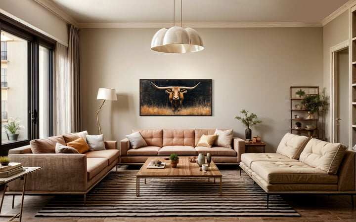 Modern Texas longhorn steer framed canvas wall art hanging above a sofa in a living room.
