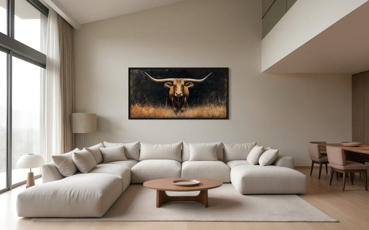 Modern Texas Longhorn steer framed canvas wall art hanging above a white sectional sofa.