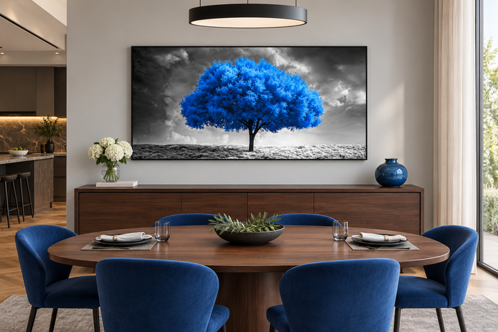 Framed canvas wall art of a vibrant blue tree against a black and white cloudy landscape.