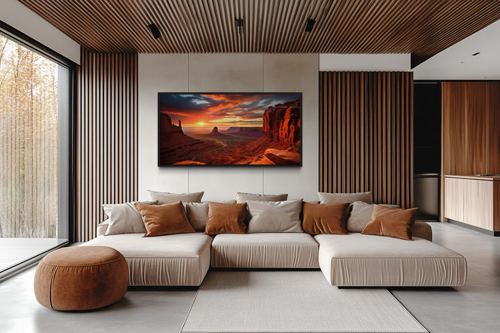 Monument Valley sunset framed canvas wall art hanging in a modern living room with a beige sofa.