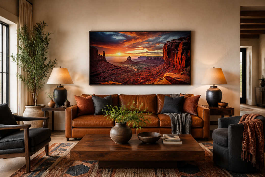 Monument Valley sunset framed canvas wall art above a brown leather sofa in a rustic living room.