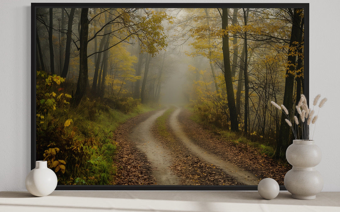 Moody foggy autumn forest framed canvas wall art featuring a misty dirt road through yellow trees.
