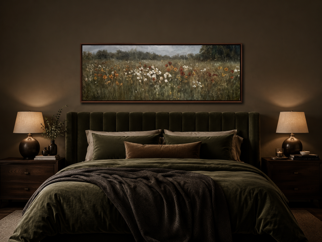 Moody horizontal canvas art of a wildflower field above a bed in a dark, earthy bedroom.