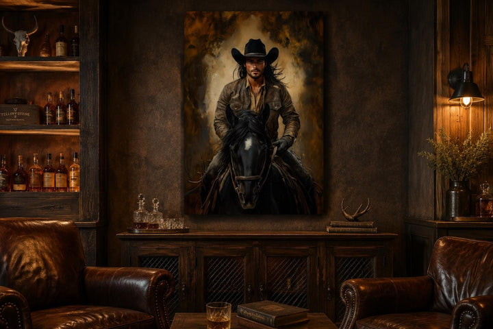 Moody canvas wall art of a cowboy on a black horse in a rustic room with leather chairs.