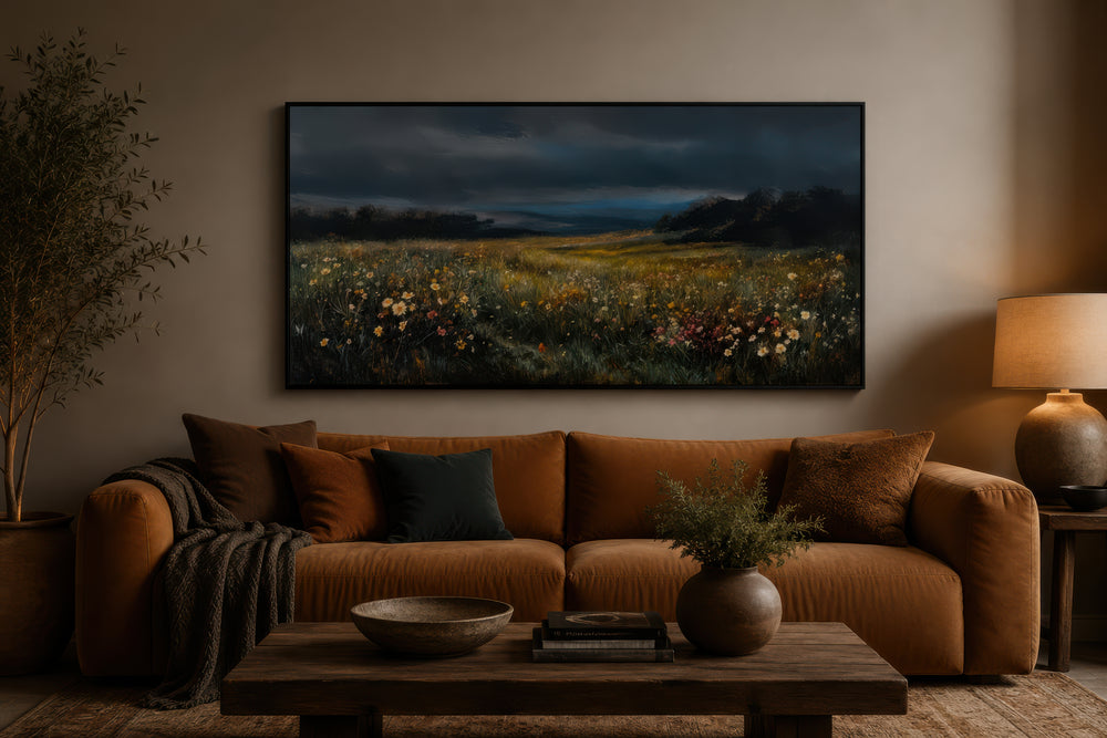 Moody wildflowers meadow at night canvas wall art above a brown sofa in a cozy living room.