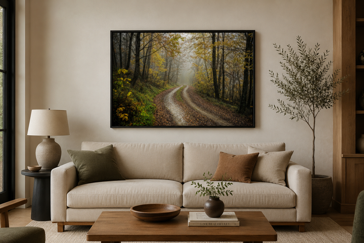 Moody Foggy Autumn Forest framed canvas wall art hanging above a beige sofa in a living room.