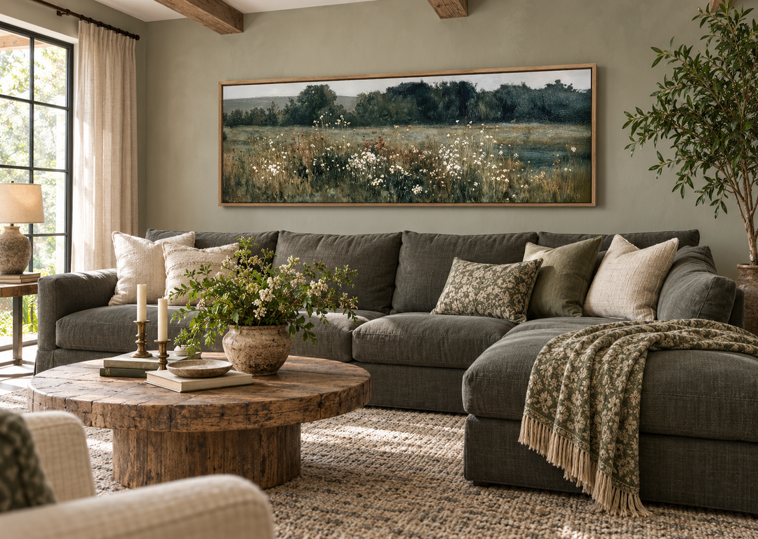 Moody Wildflowers Field long narrow horizontal wall decor above a dark grey sectional sofa.
