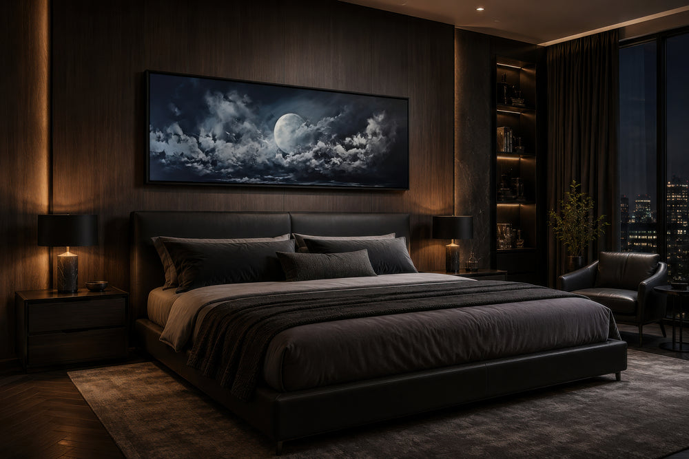 Moon and cloudy sky horizontal framed canvas wall art hanging above a bed in a dark bedroom.