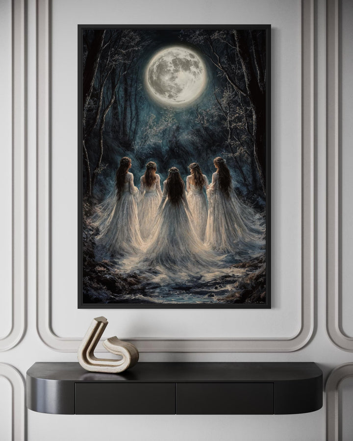 Gothic wall art of five witches in white gowns standing in a dark forest under a large full moon.