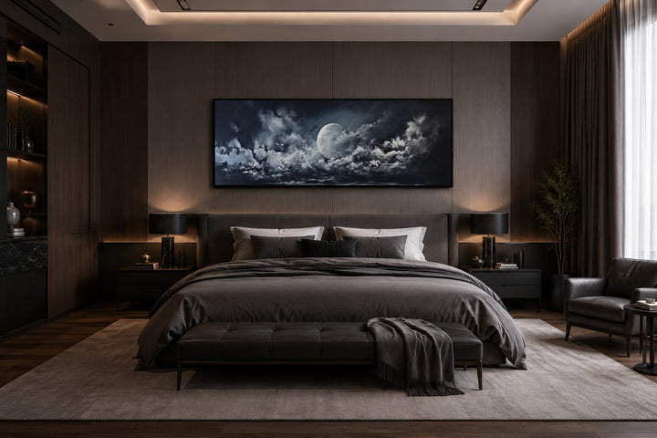 Moon and cloudy sky horizontal framed canvas wall art hanging above a bed in a modern bedroom.