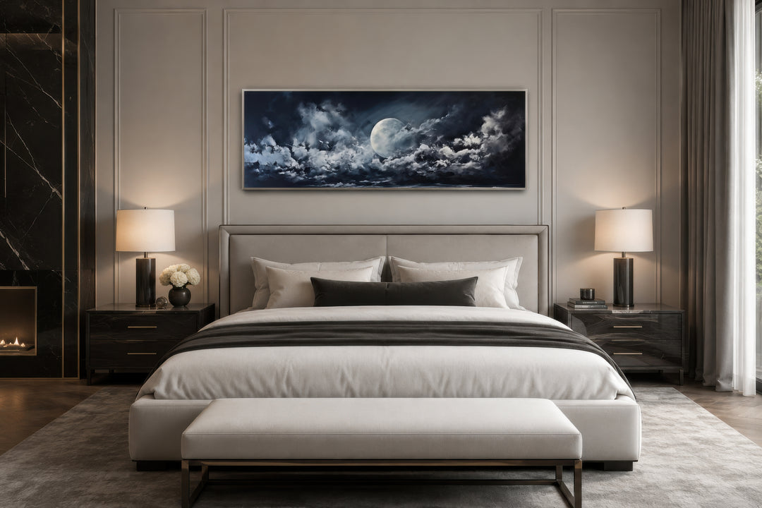 Moon and cloudy sky horizontal framed canvas wall art hanging above a bed in a modern bedroom.