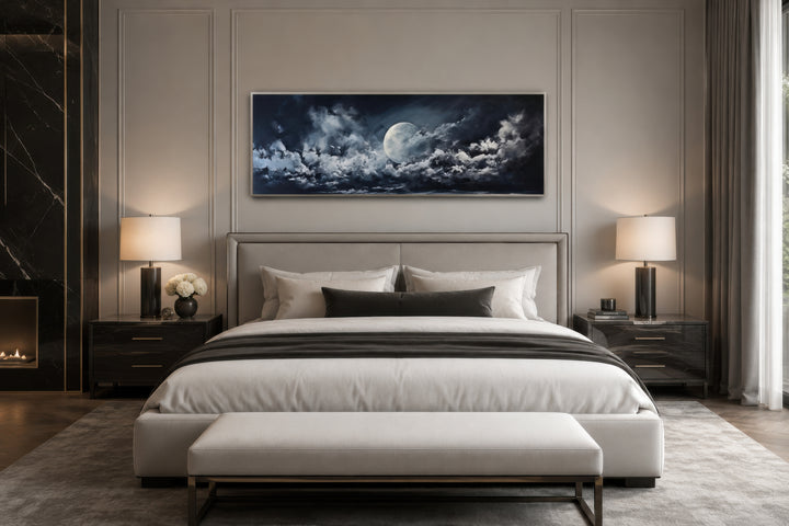 Moon and cloudy sky horizontal framed canvas wall art hanging above a bed in a modern bedroom.