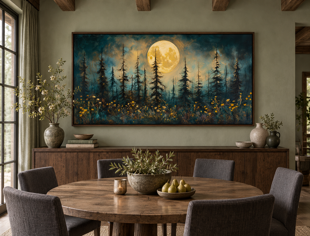 Mystical moonlit forest and wildflowers painting in a rustic frame above a dining table.