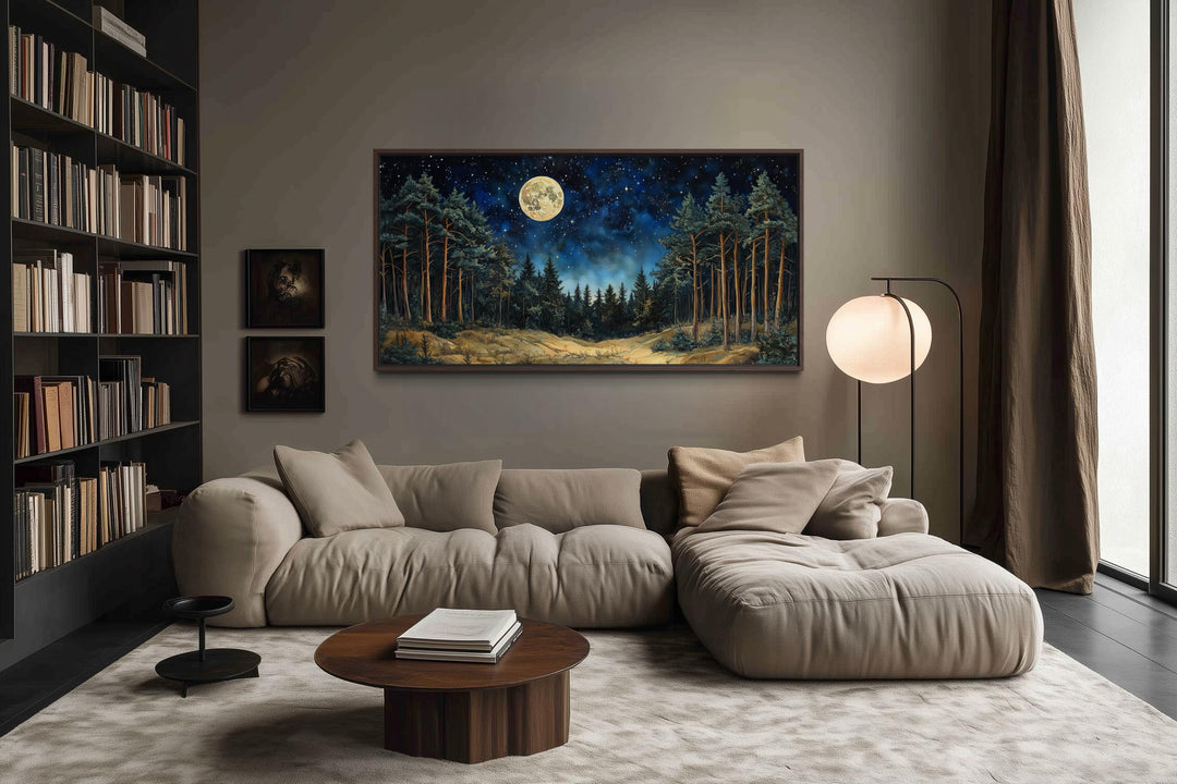 Moonlit pine forest wall art with a full moon and starry sky displayed in a modern living room.