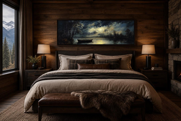 Moonlit rowboat and lake landscape long narrow canvas wall art hanging above a bed in a cabin.