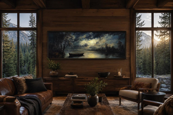 Long narrow canvas wall art of a moonlit rowboat on a still lake, hanging in a rustic cabin room.