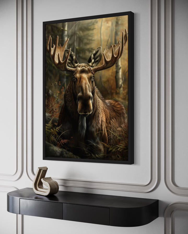 Moose In The Forest Framed Canvas Wall Art hanging above a black console table in a modern room.