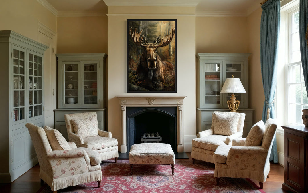 Moose In The Forest Framed Canvas Wall Art hanging above a fireplace in a rustic living room.