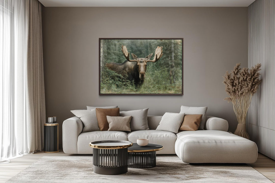 Moose in the forest wall art painting on canvas in a rustic living room above a sofa.