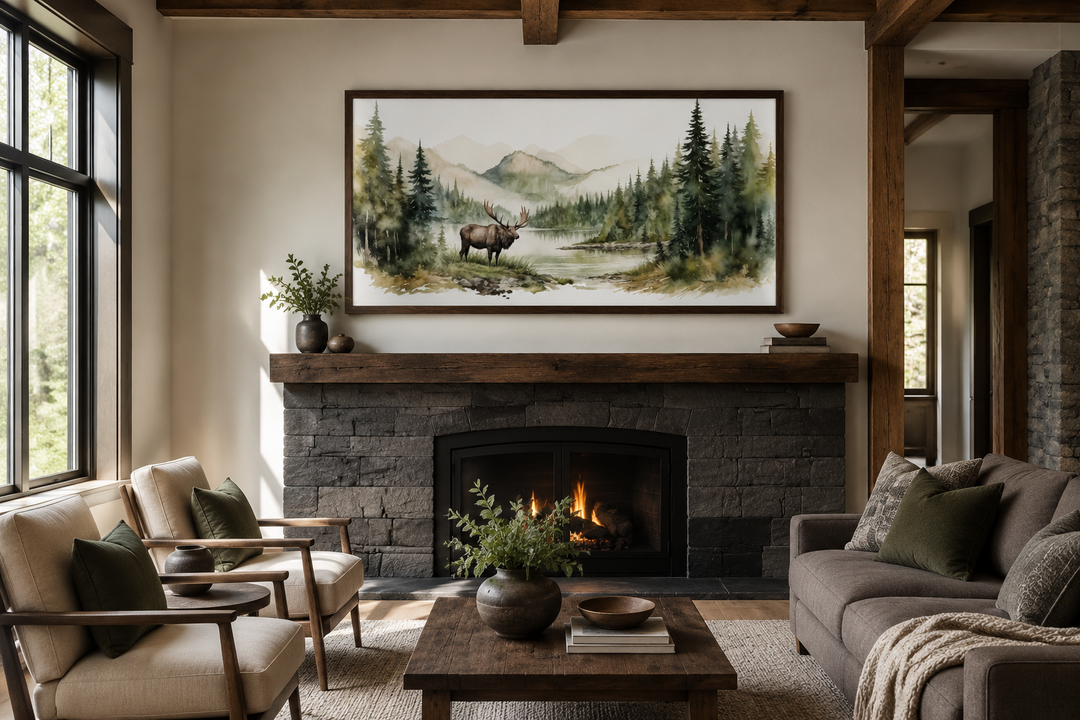 Moose in wilderness watercolor framed canvas wall art hanging above a rustic stone fireplace.