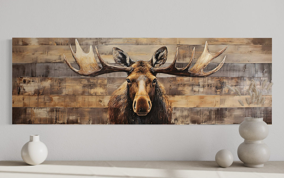 Rustic horizontal canvas wall art of a moose painted on a textured wood-plank background.