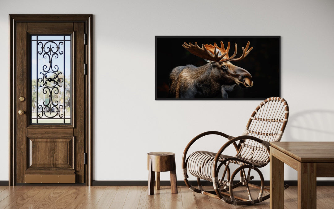 Extra large framed canvas wall art of a majestic moose on a black background in a rustic room.