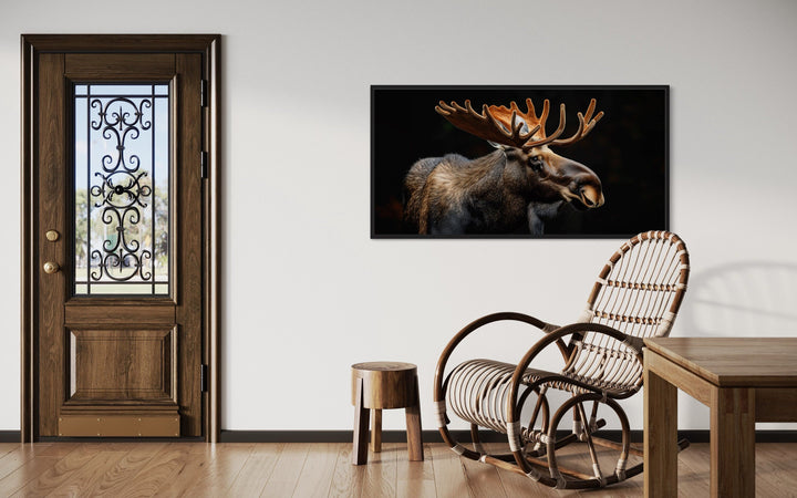 Extra large framed canvas wall art of a majestic moose on a black background in a rustic room.