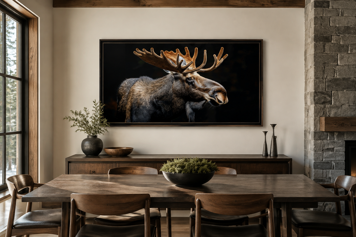 Extra large framed moose canvas wall art in a rustic dining room above a wooden sideboard.