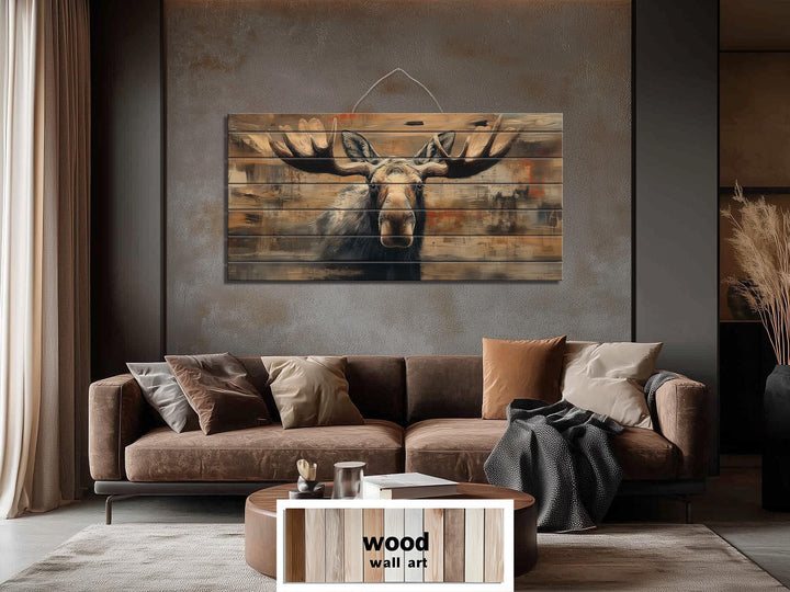 Large horizontal wood wall art featuring a realistic moose portrait on rustic timber planks.