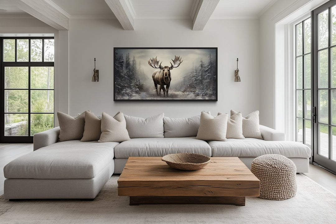 Moose in a foggy winter forest framed canvas wall art hanging above a modern sectional sofa.