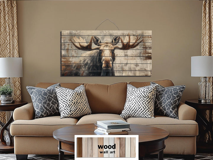 Rustic moose wall art printed on distressed wood planks hanging above a brown sofa in a living room.