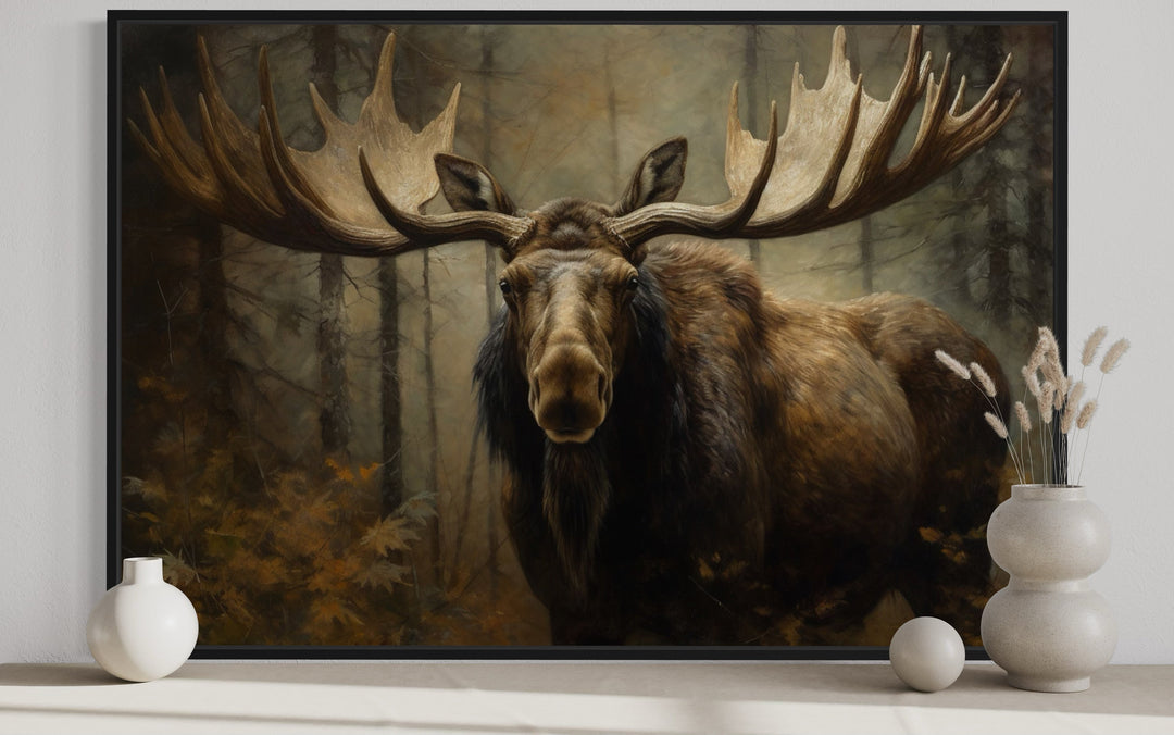 Framed canvas wall art of a moose with large antlers in a dark, misty forest.
