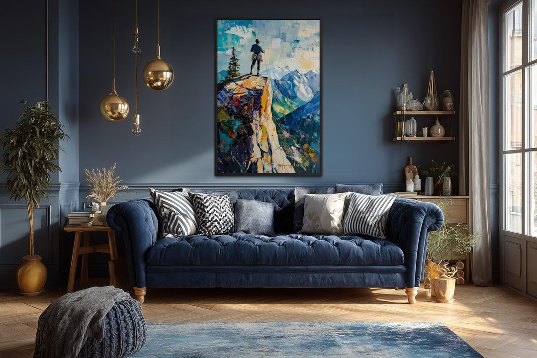 Vertical canvas print of a hiker on a cliff landscape in a modern blue living room.