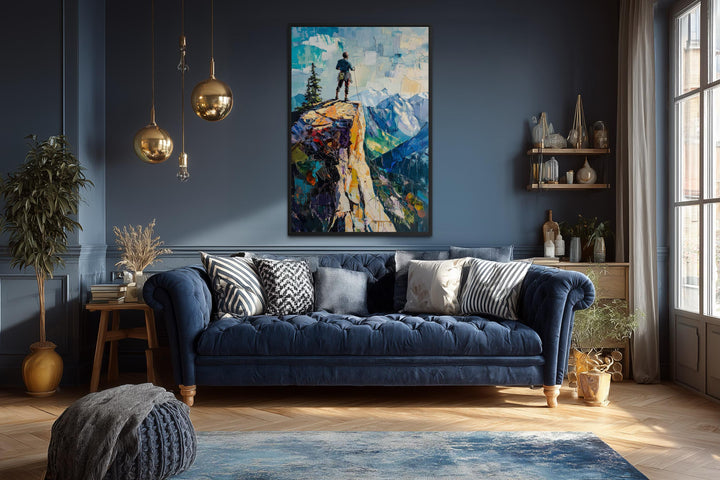 Vertical canvas print of a hiker on a cliff landscape in a modern blue living room.
