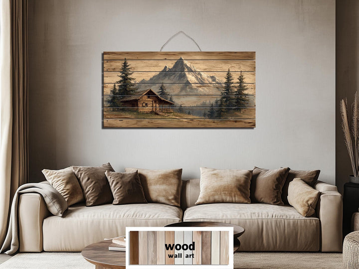 Mountain cabin distressed wood wall art with a log cabin and mountains.