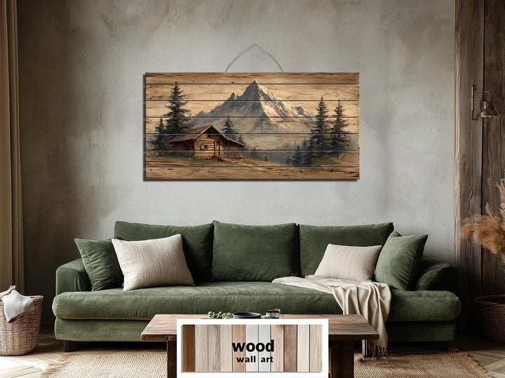 Mountain cabin distressed wood wall art with a log cabin and mountains.